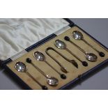 A set of six Sheffield silver bean handled coffee spoons, complete with tongs, in original fitted Ma