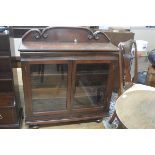 A Victorian mahogany ledgeback bookcase top, the twin glazed panel doors enclosing a shelved interio