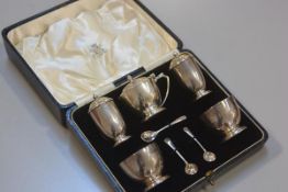 A London silver five piece condiment set including drum mustard, a pair of pepperettes, a pair of sa