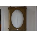 A 19thc. gilt and composition portrait frame with oval aperture with shell and C scroll moulded corn