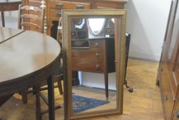 A 19thc giltwood composition rectangular framed wall mirror, with beaded and cactus leaf moulded bor