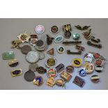 A collection of motor cycle and other cap badges including Yamaha, Triumph, Norton, Royal Enfield et