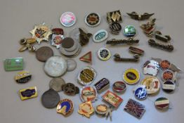 A collection of motor cycle and other cap badges including Yamaha, Triumph, Norton, Royal Enfield et