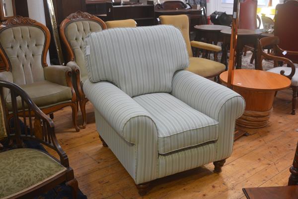 A John Lewis style drawing room easy chair with squab cushions and scroll arms, on walnut fluted tur