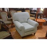A John Lewis style drawing room easy chair with squab cushions and scroll arms, on walnut fluted tur