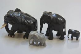 A group of three African 1920s carved ebony elephants and a carved soapstone elephant figure (4) (ta