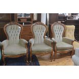 A set of three beech reproduction Victorian style button back drawing room easy chairs upholstered i