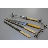 A collection of carving tools including joint holder, carving knife, two steels and a pair of Epns