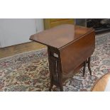 An Edwardian mahogany satinwood crossbanded sutherland tea table with twin drop flaps and cut corner