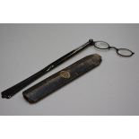 A faux tortoiseshell pair of lady's lorgnettes with fan style handle and original case by T Armstron