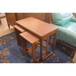 A G Plan style teak nest of three coffee tables, the larger with foldover swivel top, with twin pull
