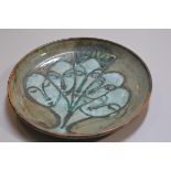 Carolina Valvona, a circular dish with incised jade green glazed heads decoration (d.33cm), £20-40