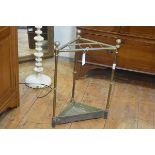 An Edwardian brass triangular shaped six division stick/umbrella stand, complete with original ename