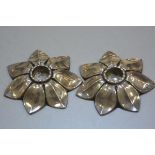 A pair of white metal candlestick holders in Scandinavian style, in the form of open flowers, unmark