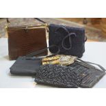 A collection of lady's handbags including a brown snakeskin bag, a black crocodile skin bag, a beade
