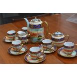 A Japanese 1920s/30s fifteen piece coffee set decorated with Noritake style landscape panels, with g