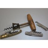 A collection of novelty corkscrews including one with treen handled eagle printed handle, a cast iro