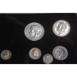 A George V presentation proof set including half crown, florin, one shilling, sixpence, threepence,