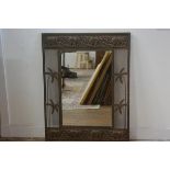 An anodised copper finish rectangular wall mirror with relief carved elephant frieze, with palm tree
