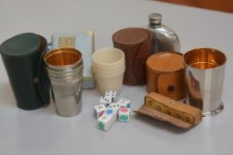 A set of four chromium plated gilt lined stirrup cups with leather case, a set of four early plastic