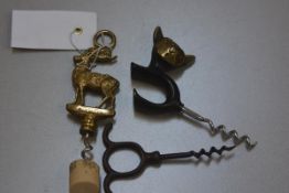 A novelty cat bronze corkscrew, an Inverness cast brass stag corkscrew and a metal corkscrew (3), £2