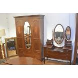 An Edwardian mahogany two piece bedroom suite comprising wardrobe, with inlaid cornice and oval cent