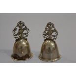 A pair of Kraftalpacca white metal pierced figure bells with engraved intials A and M (missing clapp