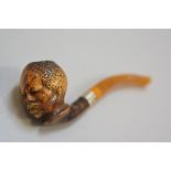 A late 19thc Meerscham blackamoor carved figure pipe with amber mouthpiece and silver mount (l. 13cm