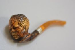 A late 19thc Meerscham blackamoor carved figure pipe with amber mouthpiece and silver mount (l. 13cm