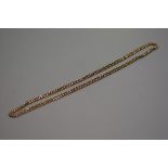 An Edwardian 9ct gold curb link guard chain (63cm), stamped 9ct (24.31g), £250-350