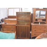 A 1970s walnut upright twin sliding glazed door and twin panel door bookcase with adjustable shelves