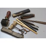 A collection of miscellaneous tools including a scribing tool, a folding corkscrew, a corkscrew,