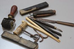 A collection of miscellaneous tools including a scribing tool, a folding corkscrew, a corkscrew,