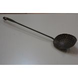 A 19thc A Christie copper skimming spoon with scroll end (a/f) (l. 63cm. bowl d. 12cm)