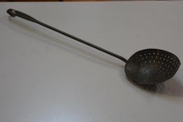 A 19thc A Christie copper skimming spoon with scroll end (a/f) (l. 63cm. bowl d. 12cm)