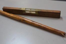 An E Preston & Sons, treen brass mounted spirit level (h. 5cm x l. 46cm) and a Bosun's stick (l.