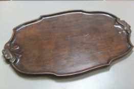 A nice Edwardian oval mahogany scalloped bordered tea tray with fan shell scroll carved handles to