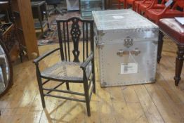 An Edwardian Arts & Crafts style child's spindle back cane seat open armchair, on turned supports (