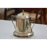 An Epns Art Deco style two handled tapered cylinder biscuit barrel with hinged knop top, raised on