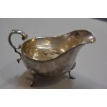 A Birmingham silver George III style sauceboat with gadroon border and C scroll handle, on pad feet,