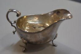 A Birmingham silver George III style sauceboat with gadroon border and C scroll handle, on pad feet,