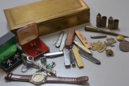 A rectangular brass three section cigarette box, a collection of various novelty pen knives, a