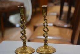 A pair of Edwardian cast brass candlesticks raised on circular moulded bases (h.25cm)