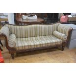 A William IV walnut Regency style scroll end drawing room sofa with inlaid panel back and fluted