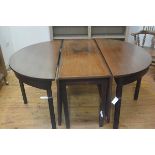 A George III mahogany double D end extending dining table with centre twin drop flaps, with