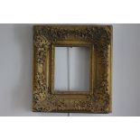 An oak and composition gilt rococco style frame with acanthus leaf and C scroll decoration (aperture