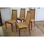 A set of four 1970s teak G Plan panel back and seat dining chairs with original upholstery, raised