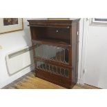 A Chapter Simpoles mahogany four section bookcase with three leaded up and over glass doors (top