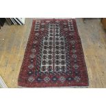 An Afghan prayer rug, the shaped panel with stylised leaf design enclosed within a multiple