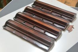 A set of four Chinese cherrywood Mahjong brick holders (two with losses) (h. 4cm x l. 40cm x d.